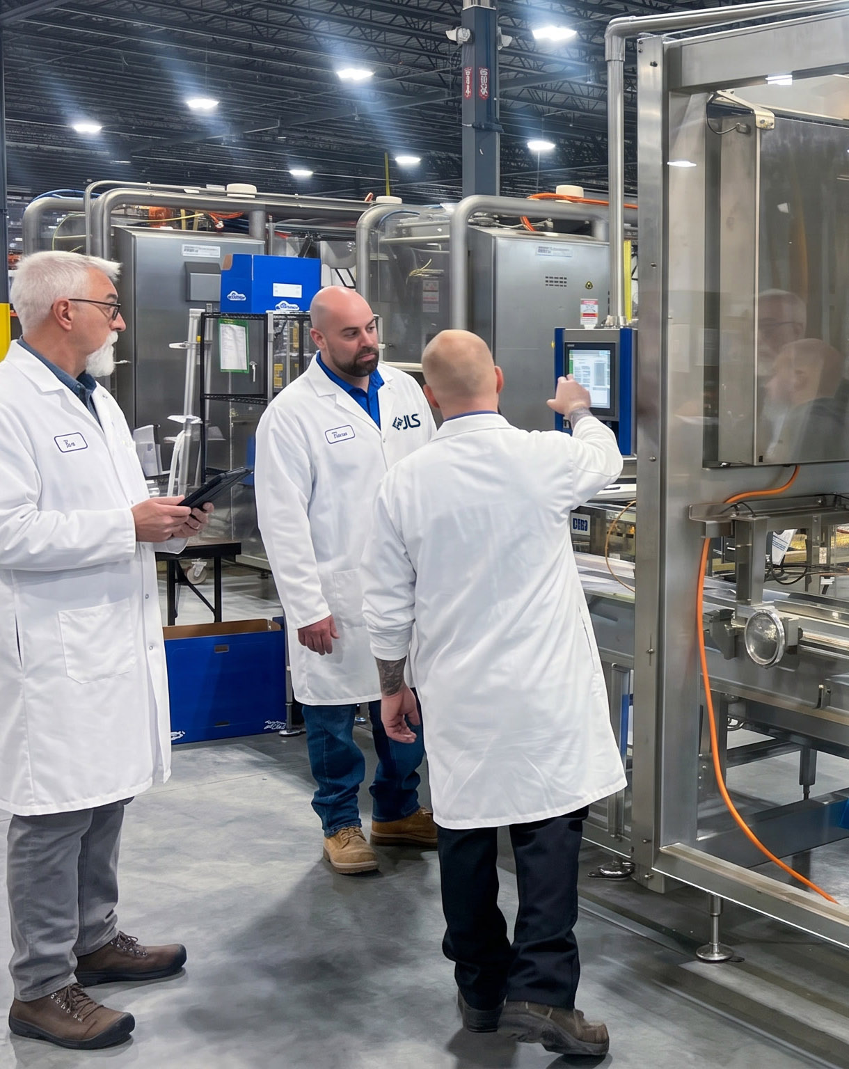 JLS engineers running a customer product test on a live robotic cell in the Flight Lab
