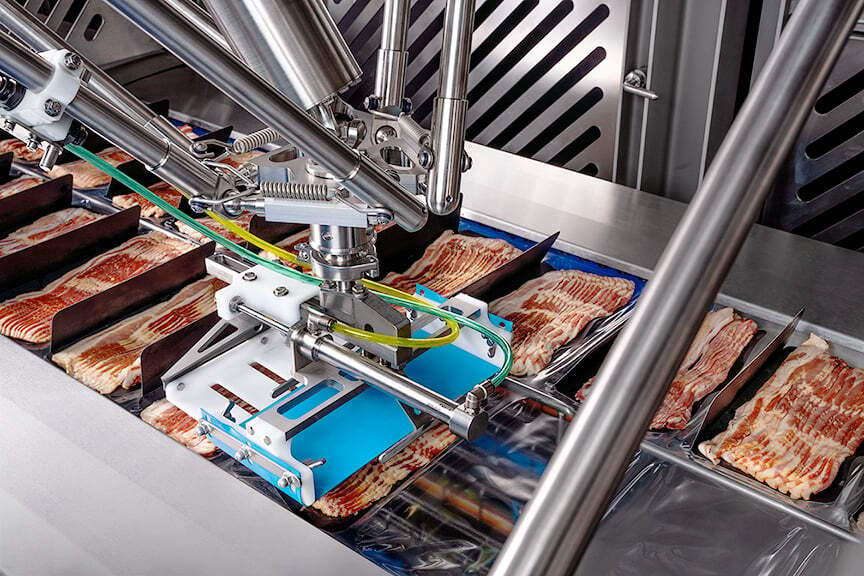 Talon Harrier robot loading sliced bacon drafts into a thermoformer